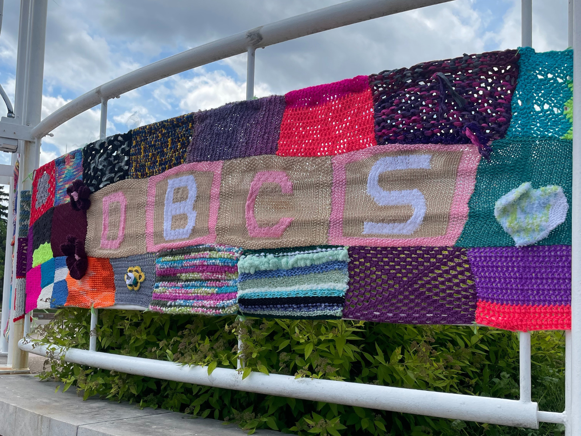 DBCS yarn bombing on a fence 