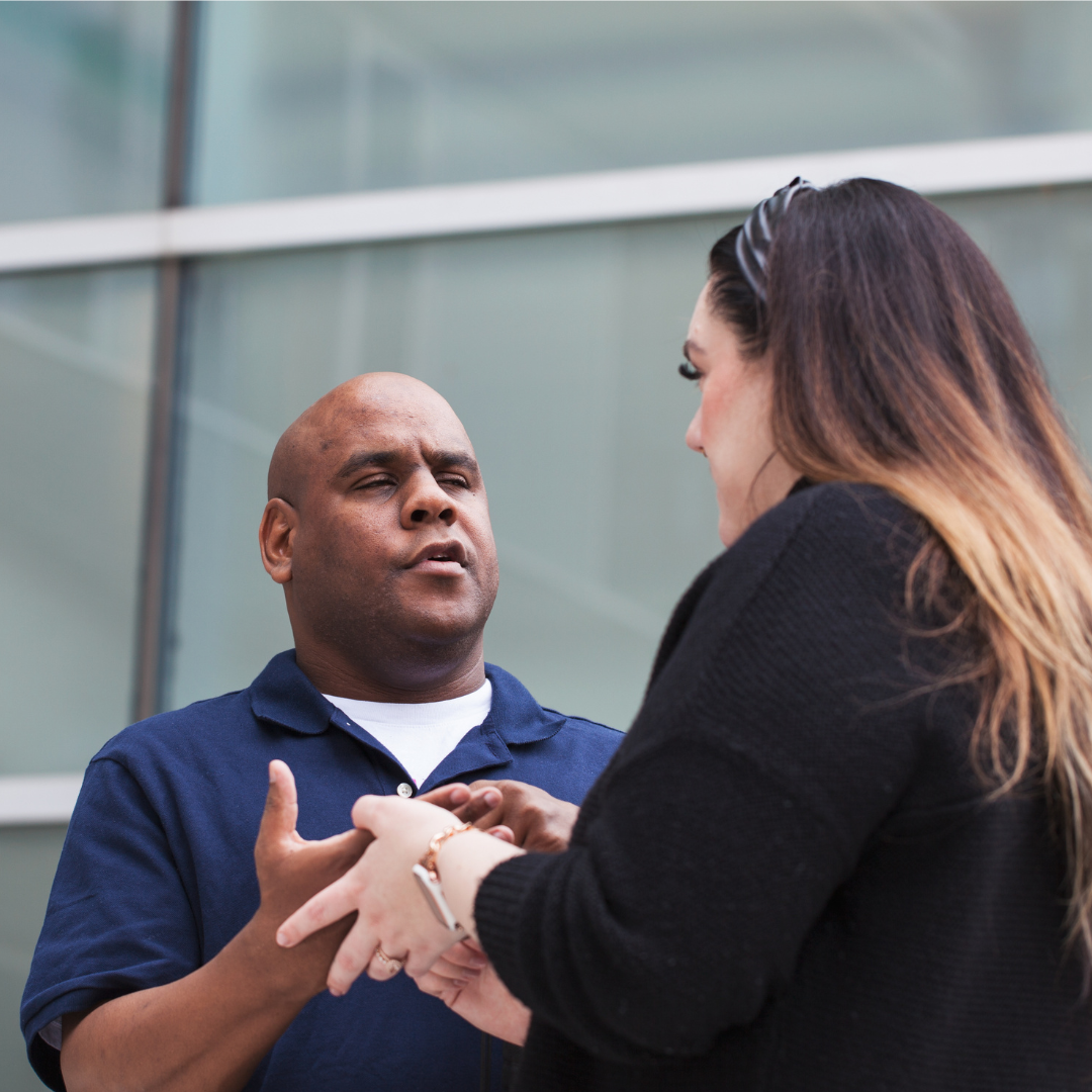 An intervenor uses print on palm to communicate with a client. 